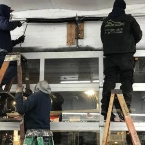 Garage door torsion spring repair by technicians in Bronx, NY — H&O Garage Doors team on-site