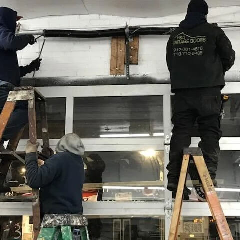 Garage door torsion spring repair by technicians in Bronx, NY
