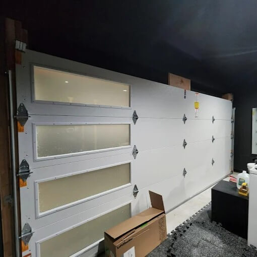 Garage door installation with insulated panels and windows in Bronx, NY