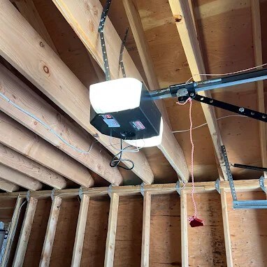 Garage door opener installation on ceiling joists in a Brooklyn home