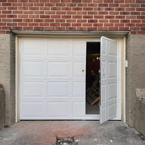 White garage door with side access door installed at a Brooklyn property