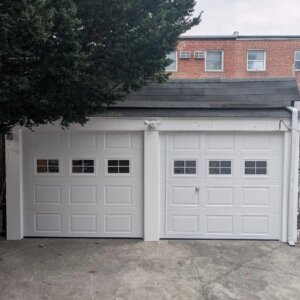New white double garage doors installed for a homeowner in Queens, NY