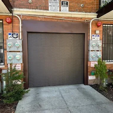 New brown garage door installed at a Brooklyn residential building.