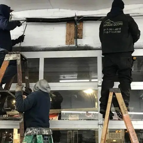 Garage door torsion spring repair by technicians in Bronx, NY