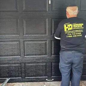 H&O Garage Doors technician performing garage door repair in Brooklyn, NY