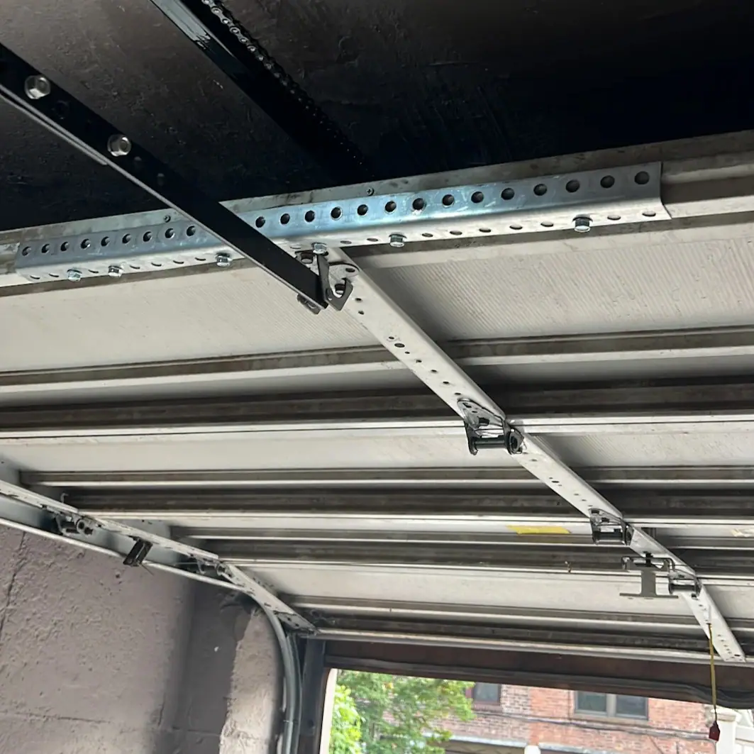 Garage door track and reinforcement hardware repair completed in Queens, NY